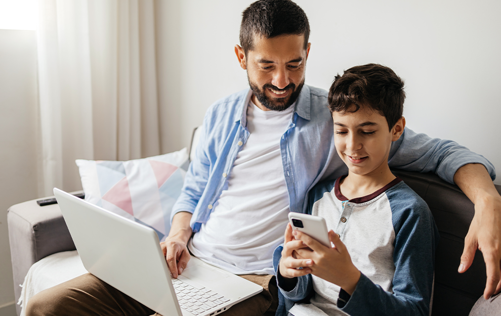 Father with son holding a smartphone